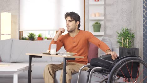 The-physically-disabled-young-man-is-at-home.